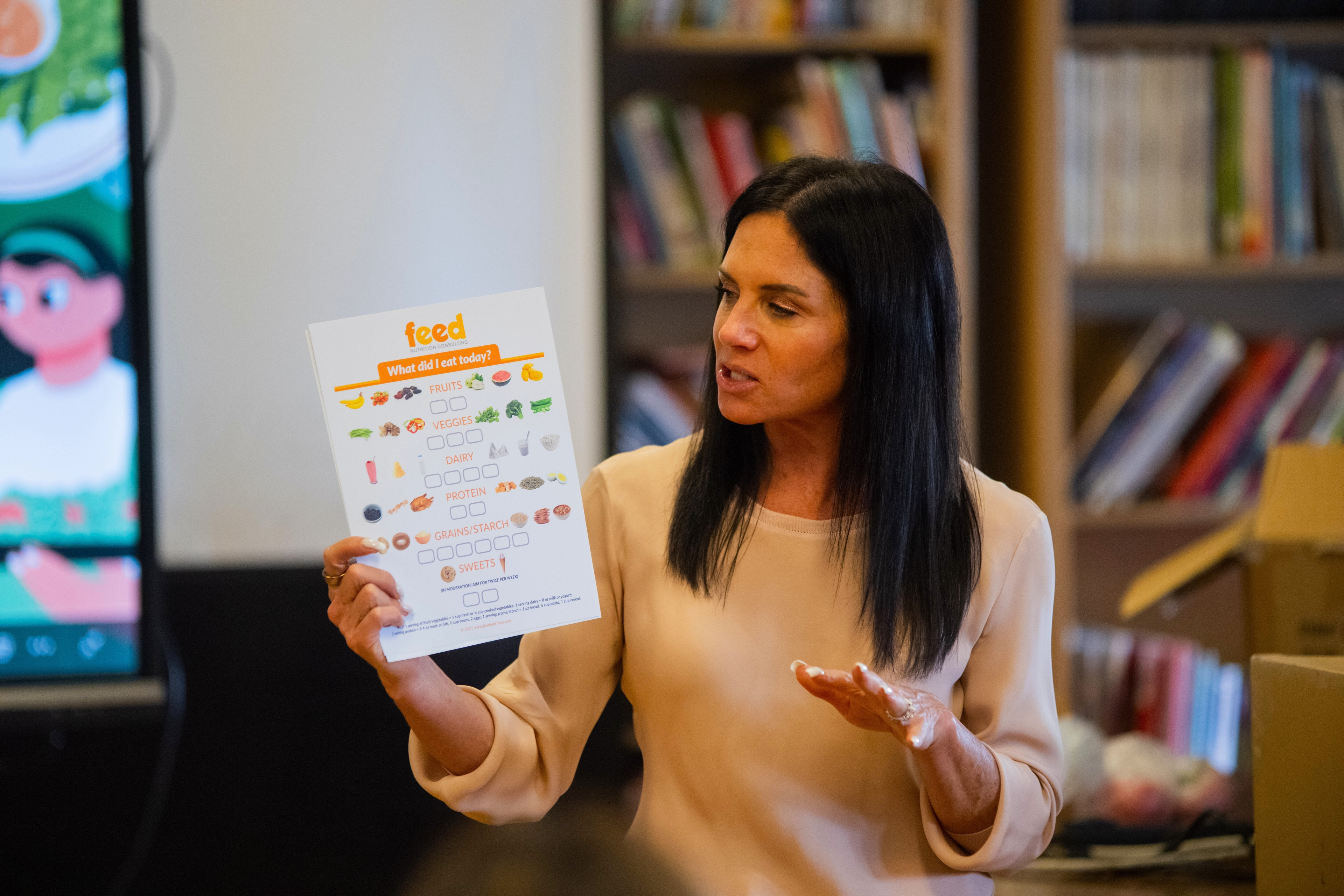 Nutritionist walking Talcott students through a food-group worksheet during the curriculum unit.