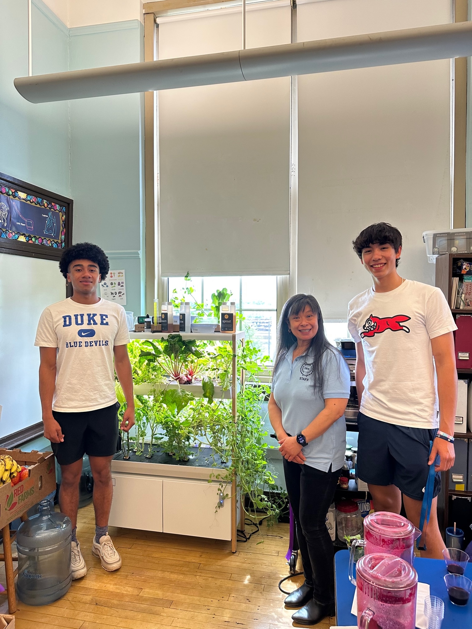 James Ward install team with teacher Jenny Croitoru beside the new hydroponic system.